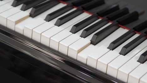 grand piano. professional piano keys self playing. close-up seamless loop. for classical musical music education. black and white piano keys that play on their own. ai self playing without pianist.