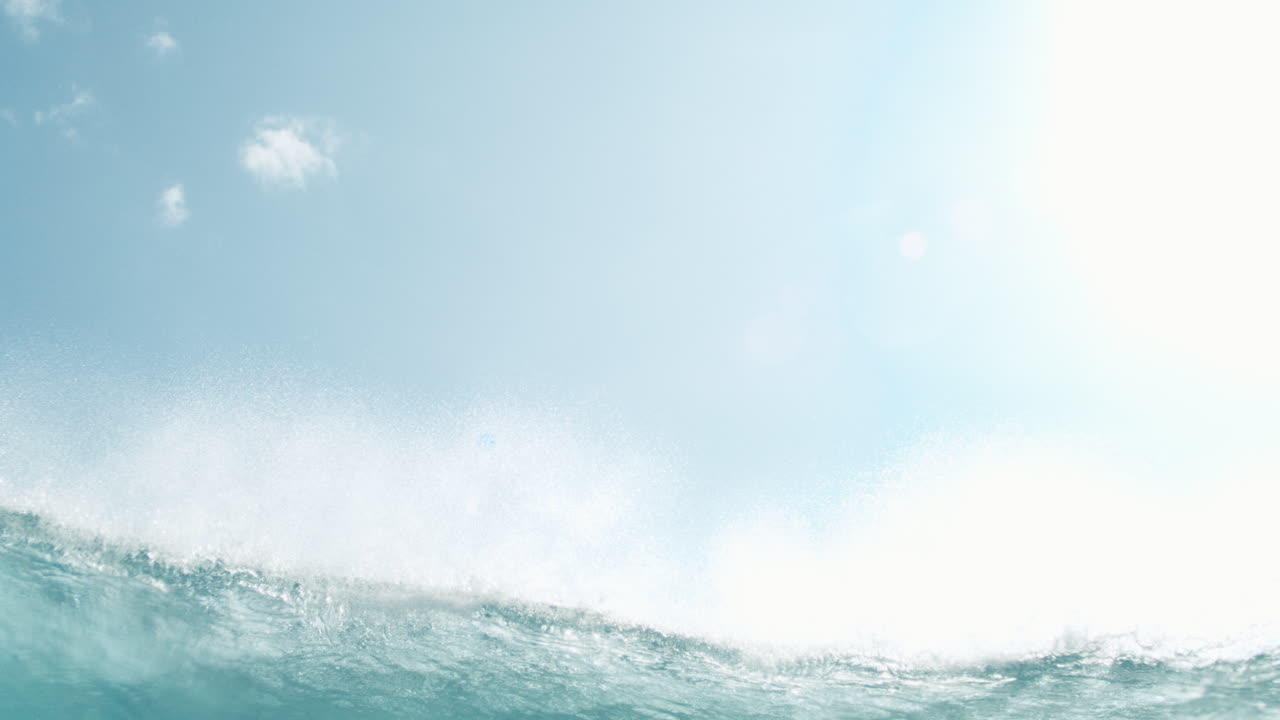 Calm glistening ocean surface with slow ripples under soft morning sky