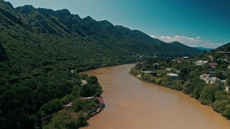 river valley scenery with city and mountains
