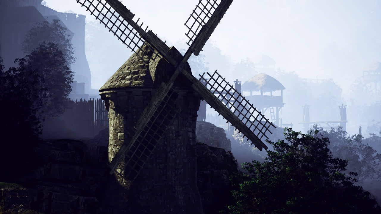 Historic windmill stands tall amidst fog in a tranquil countryside landscape