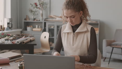 woman decorating christmas gift boxes