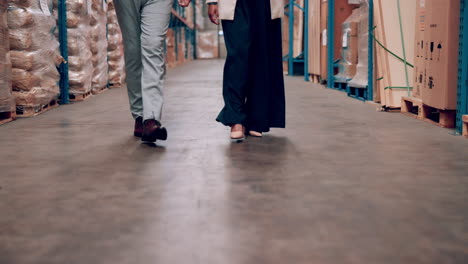 business people walking through warehouse