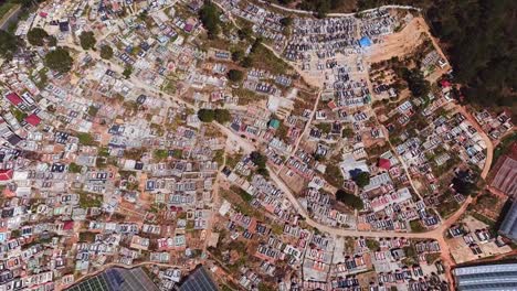 drone flying over graveyard near dalat, vietnam. aerial view of burial structures at cemetery.