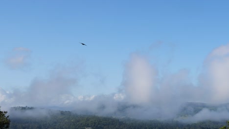 clouds moving over a mountainous landscape