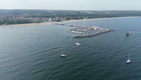 yachts and sailboats sailing on baltic sea near marina in sopot aerial shot, poland