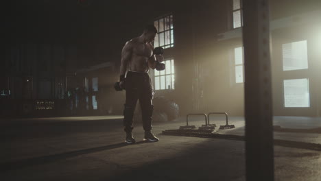 man working out with dumbbells in a gym