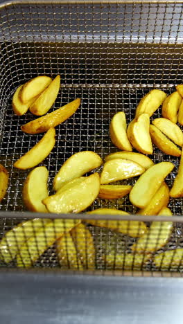 french fries frying in commercial fryer