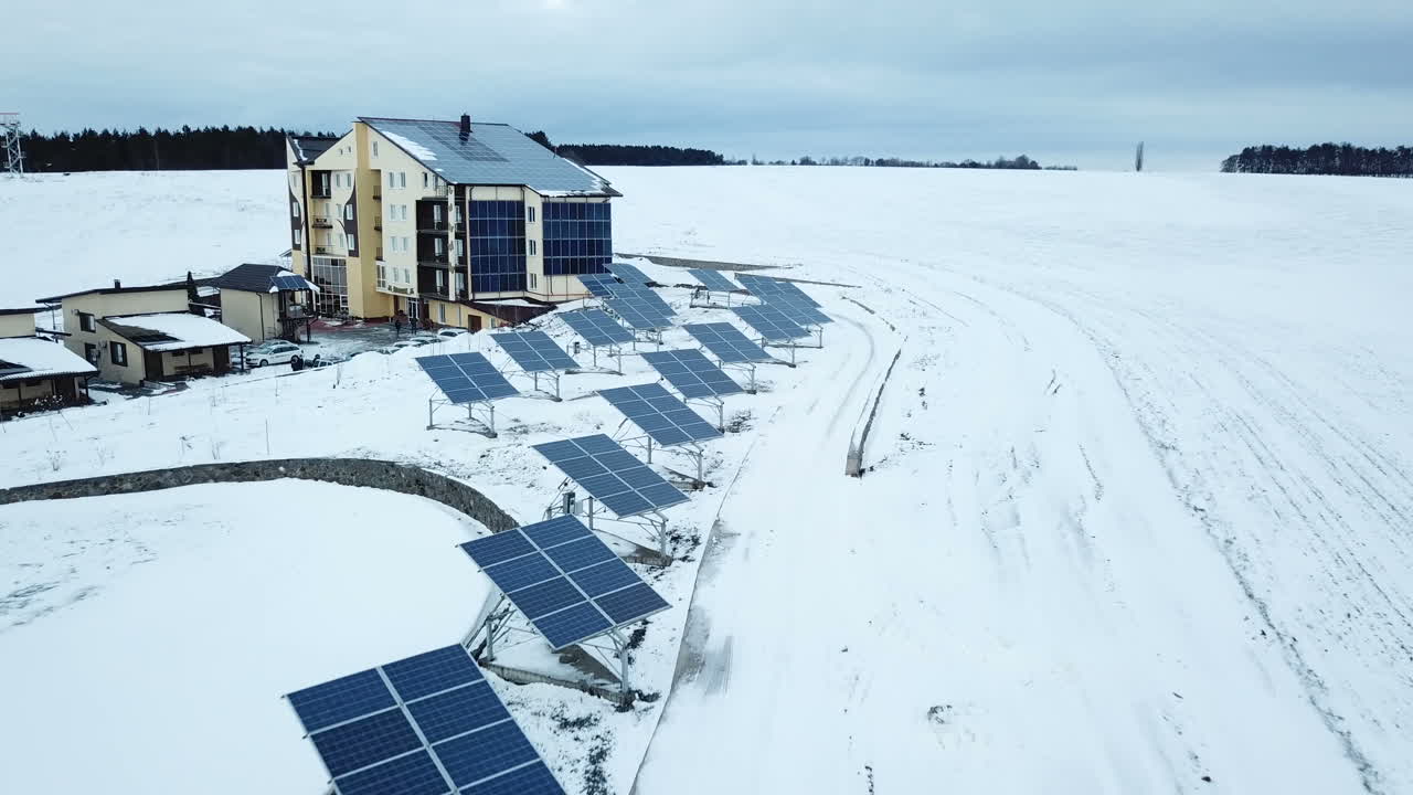Recreation center with solar panels covered with snow on the outskirts of the city.