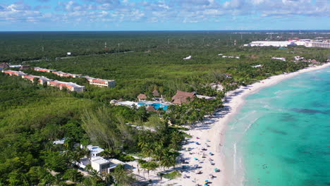 aerial-of-beautiful-white-sand-beach-in-Playa-Xpu-Ha-Mexico-on-sunny-summer-day-with-turquoise-blue-water-with-gentle-waves-crashing