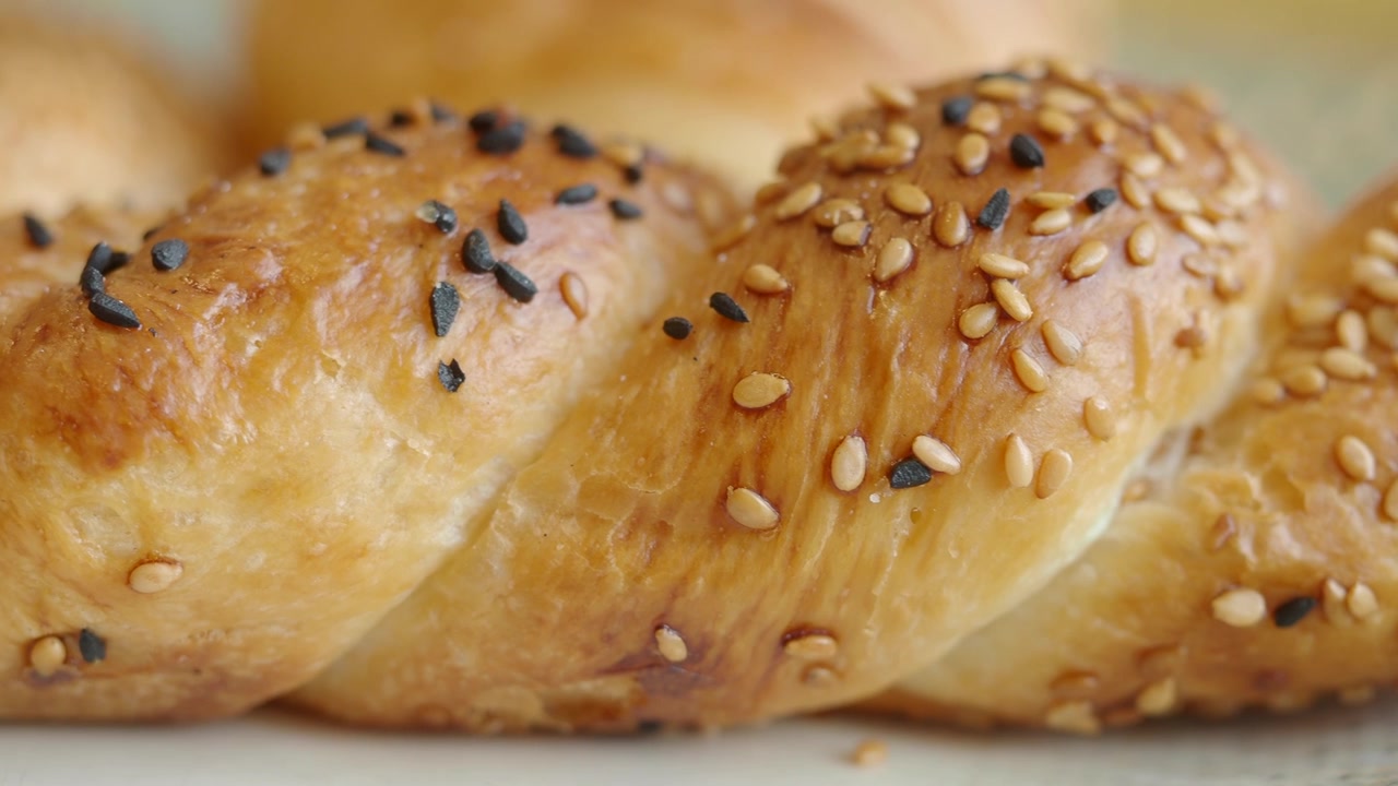 Close-up of Freshly Baked Braided Bread with Sesame Seeds