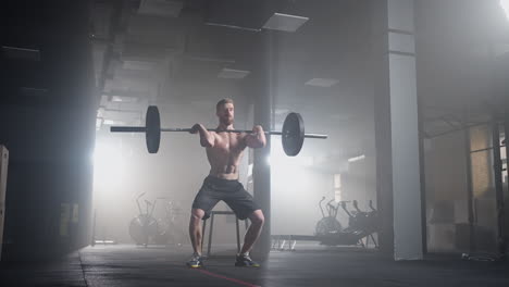 slow motion: man doing deadlift exercise at gym