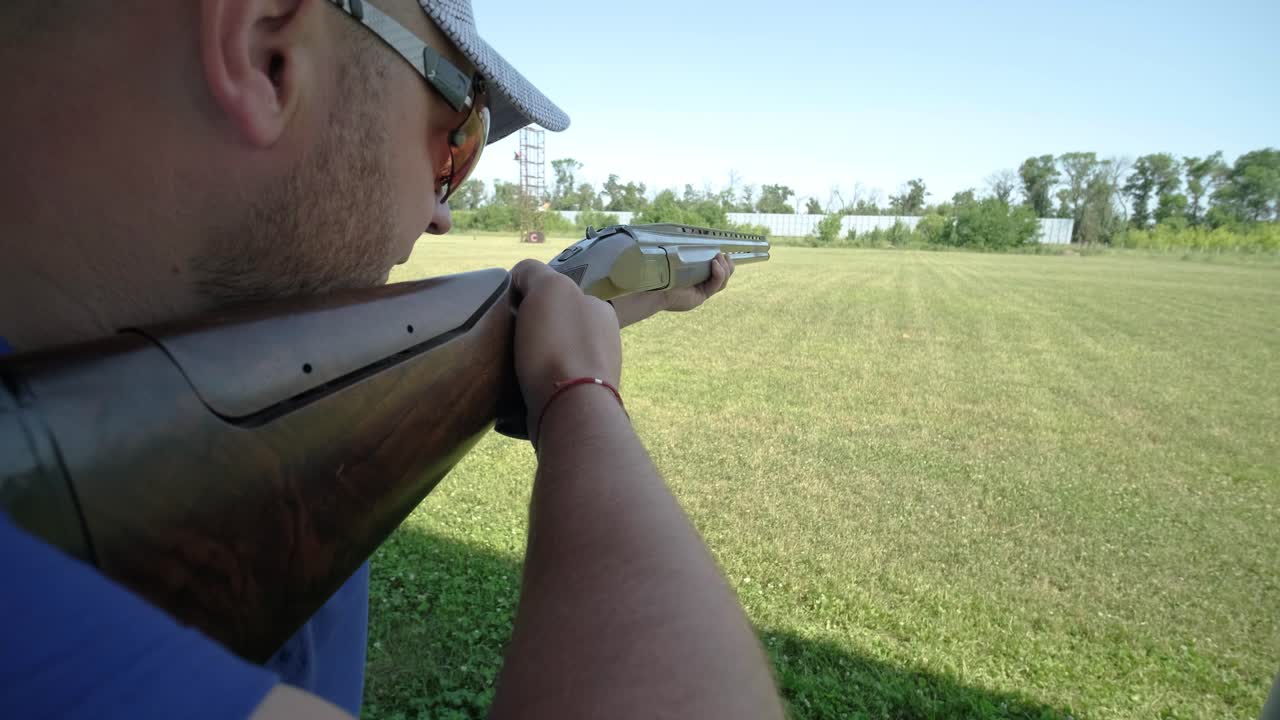 Sportsman shoots from a double-barreled shotgun, A sports field for a shooting test is shooting at flying skeet