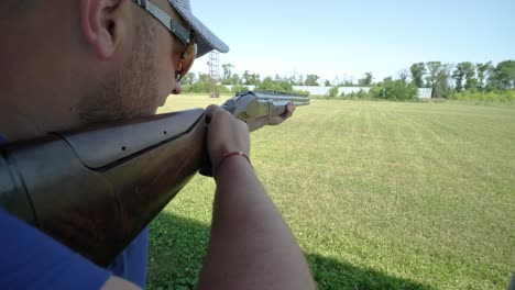 sportsman shoots from a double-barreled shotgun, a sports field for a shooting test is shooting at flying skeet