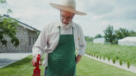 senior farmer painting metal fence