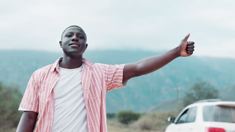 man hitchhiking on a road
