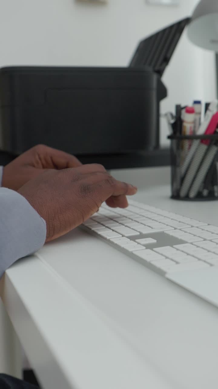 Vertical Video Of Black Male Typing On Keyboard In Home Office