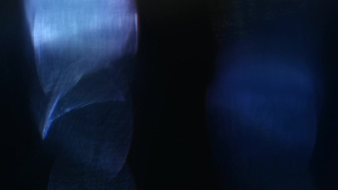Dynamic Blue and Green Light Leaks Overlay on Black Background