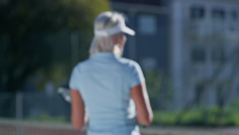a woman holding a tennis racket on a tennis court