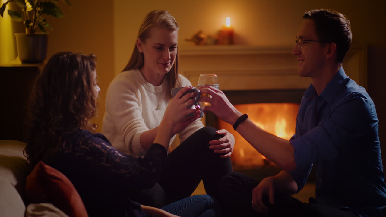 People enjoying conversation around a fireplace