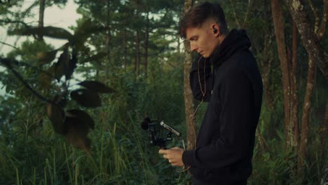 photographer recording audio in forest