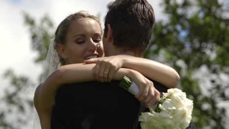 bride and groom kissing each other outside