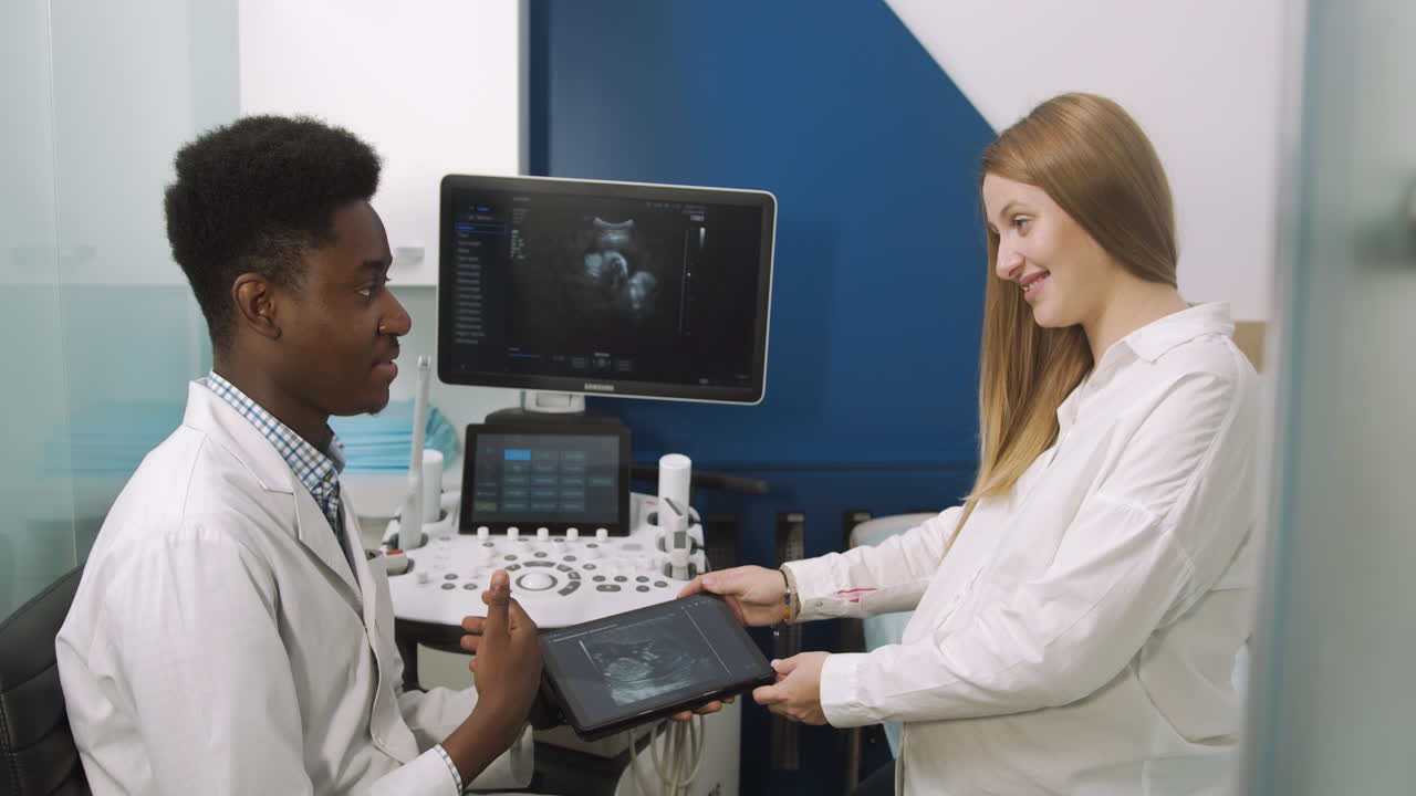 Doctor Discussing Ultrasound Results with Pregnant Patient