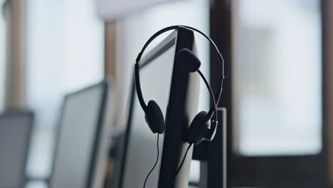 Woman-hand-taking-headset-from-computer-closeup.-Businesswoman-work-call-center