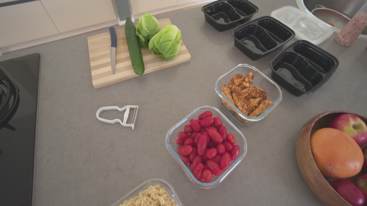 Camera is starting to pan and tilt on counter showing cutting board with knife and grains