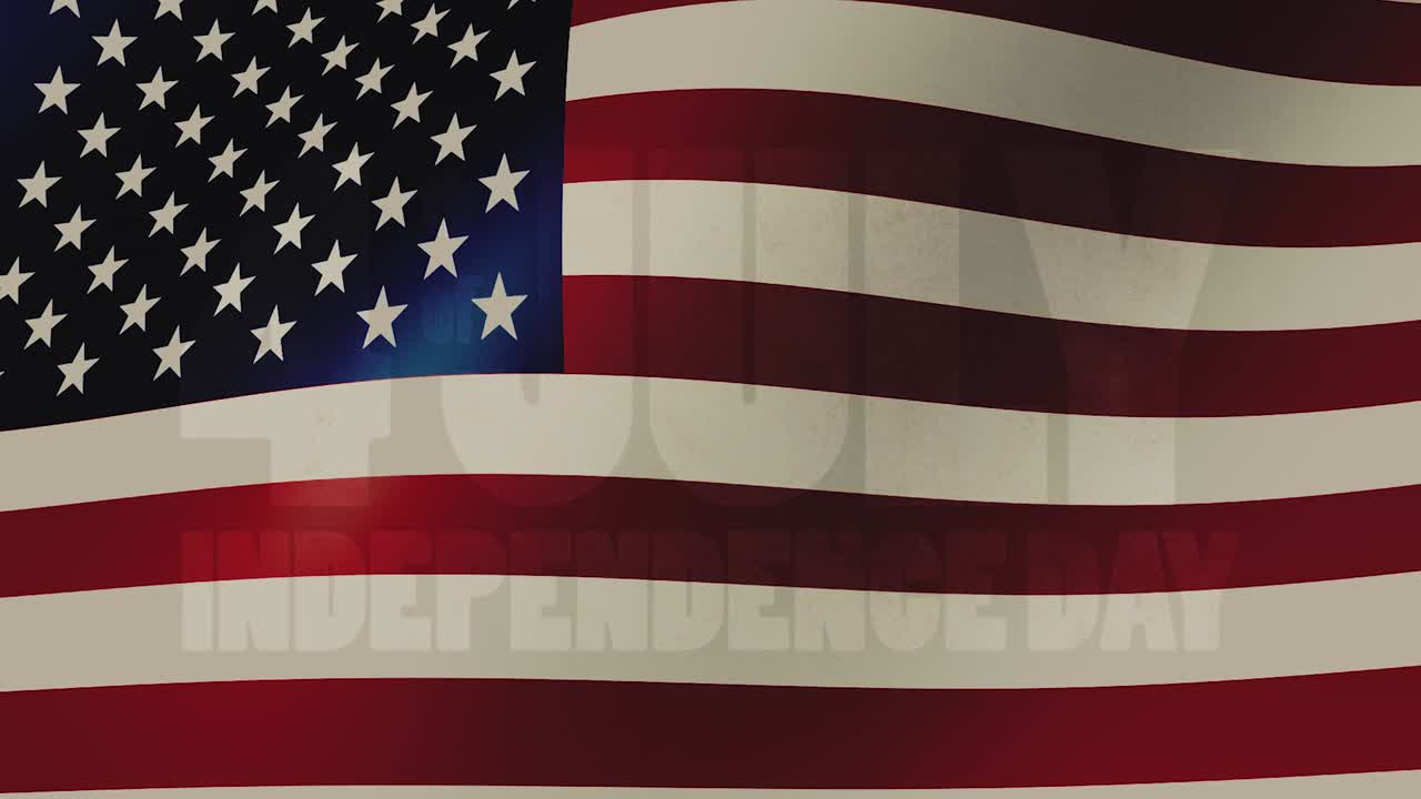 Festive fireworks in the form of the text - 4 th of july Independence Day - against the background of a waving USA flag.