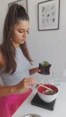 young woman preparing matcha tea