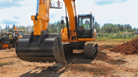 heavy caterpillar excavator excavation on construction site. orange excavator