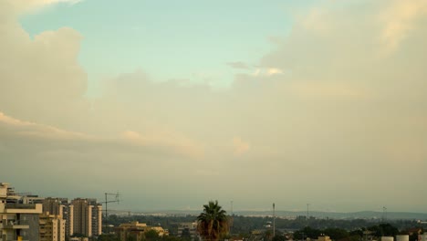 a stunning day to night time lapse of a sunset above the city, was shot from the roof, israel tel aviv, middle east, colorful surfing clouds, golden hour, cityscape, sony 4k video