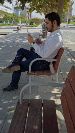urban break, businessman using tablet in park
