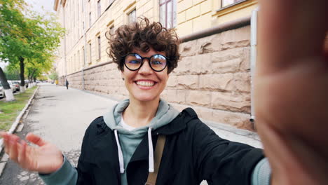 mujer tomando una selfie en una calle de la ciudad