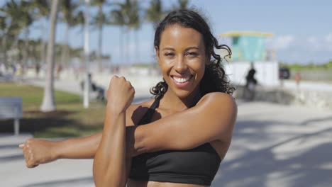 Cheerful-girl-warming-up-in-park