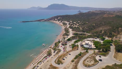 Aerial-view-approaching-Paradise-Beach-from-hills,-Kos,-Greece