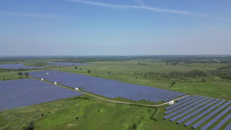 large solar farm panels for electricity production - aerial drone shot