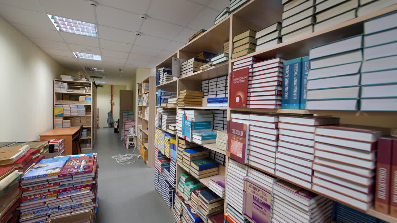 Books on wooden shelf in library. Modern design in library interior with functional shelf system