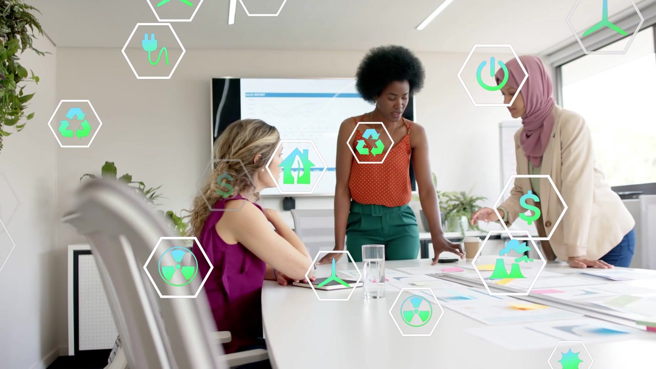 Right woman tapping tablet launching floating hex icons, team reviewing charts for green finance