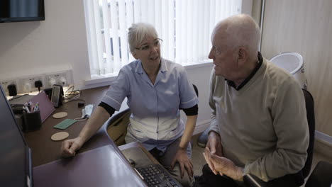 nurse assisting elderly patient with healthcare at home