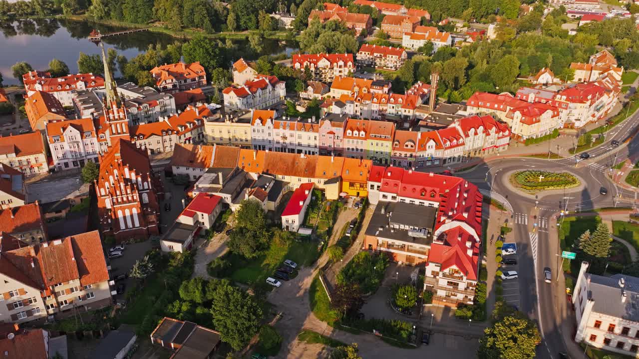 Cinematic sunset aerial drone establishing shot of Ketrzyn Poland town buildings
