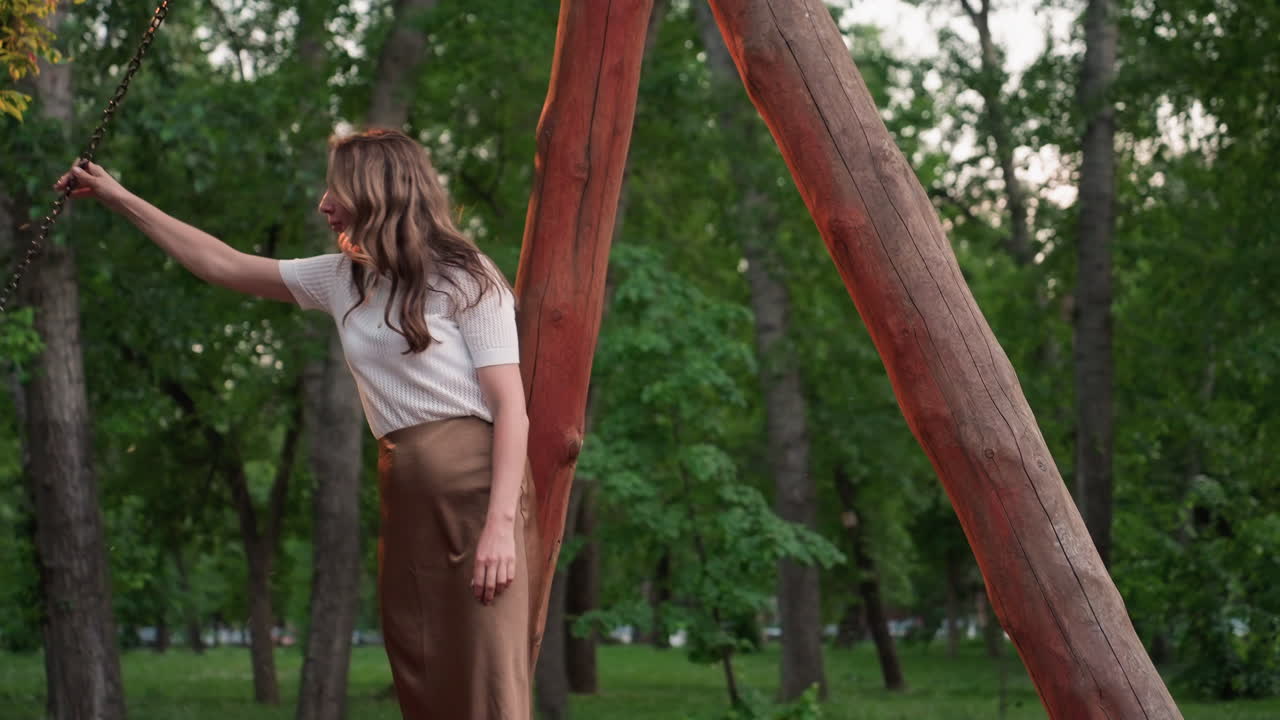 summer children swinging high in leafy park while parents gently support swing chains under warm evening light capturing joyful laughter and playful family moment outdoors smiling together