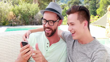 happy homosexual couple on mobile phone