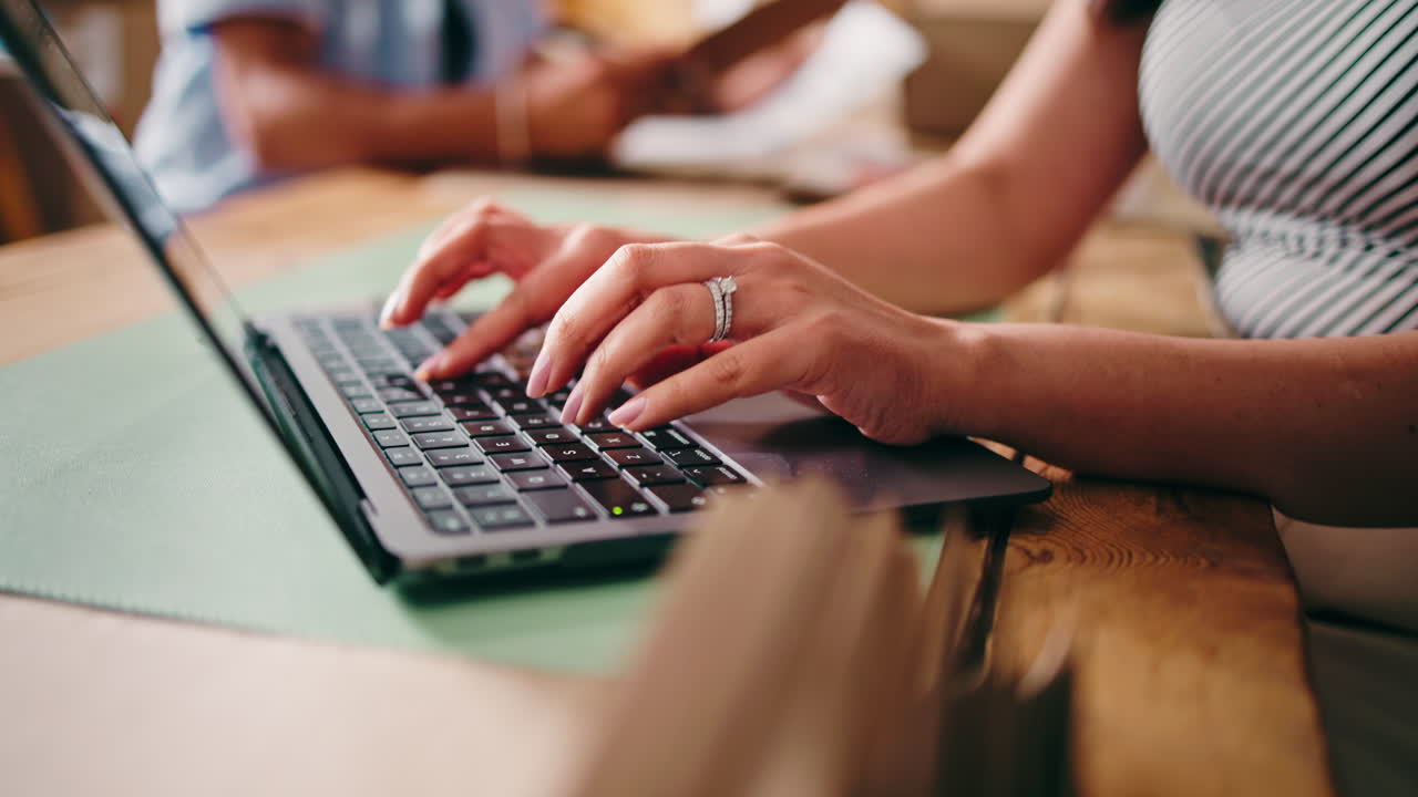 Close Up of Woman's Hands Typing on Laptop Keyboard