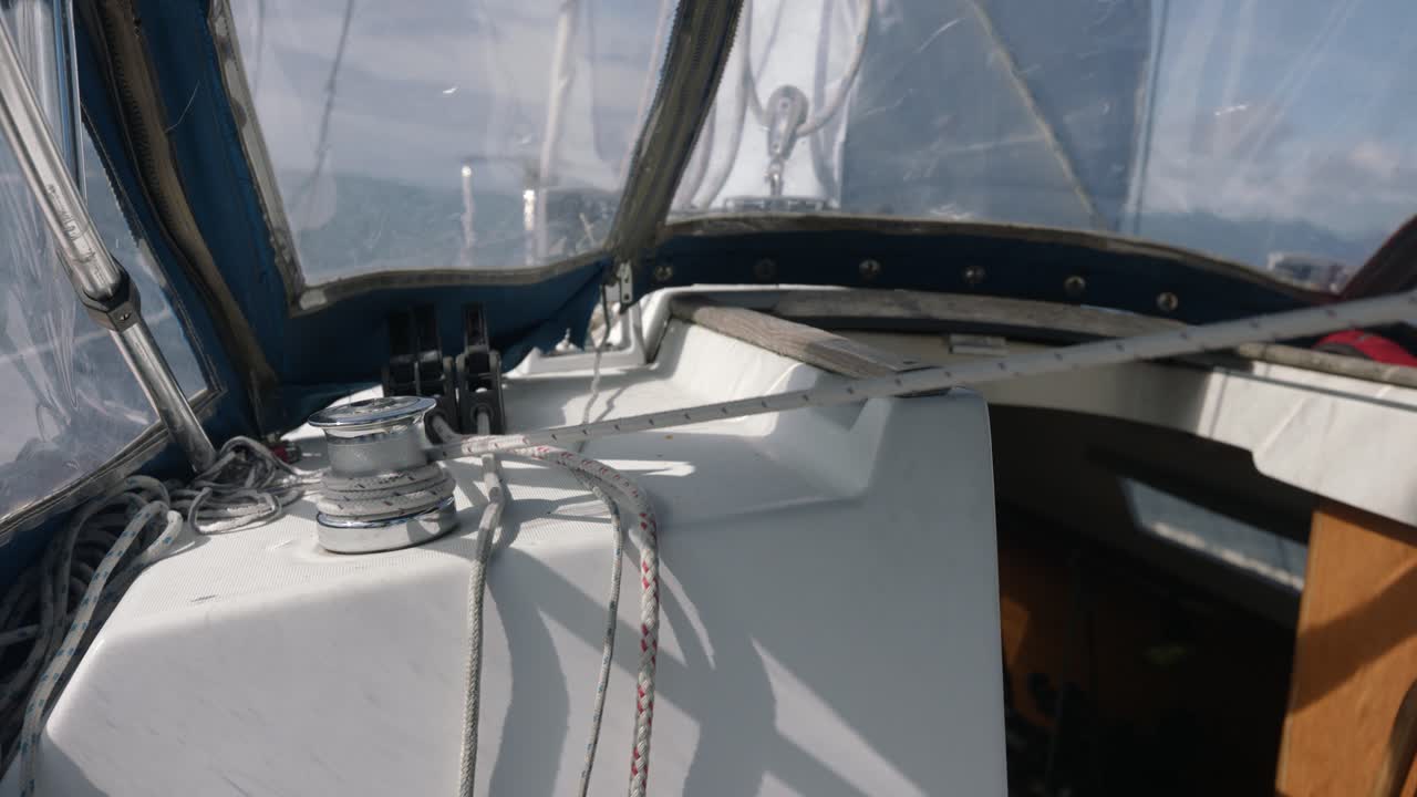 Male Hands Pulling Rope From Winch on Sailboat Deck Slow Motion