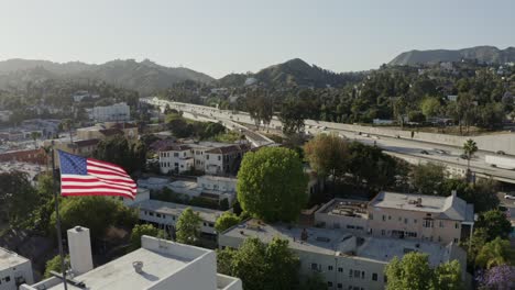 flag in wind with freeway in background - alternate - hollywood, california