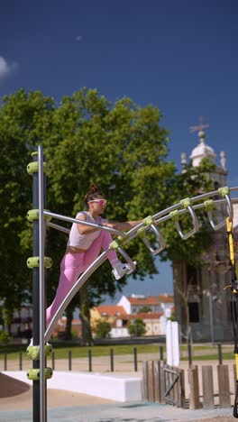 woman exercising outdoors on park equipment
