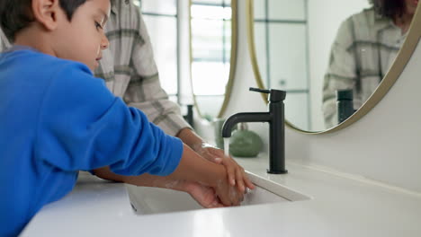 woman, child and washing hands in bathroom