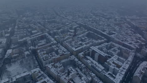 Aerial-panoramic-footage-of-winter-snowy-city.-Urban-neighbourhood-with-blocks-of-apartment-buildings.-Berlin,-Germany