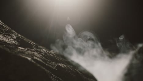 close up view of rocks in the smoke, mountains at night